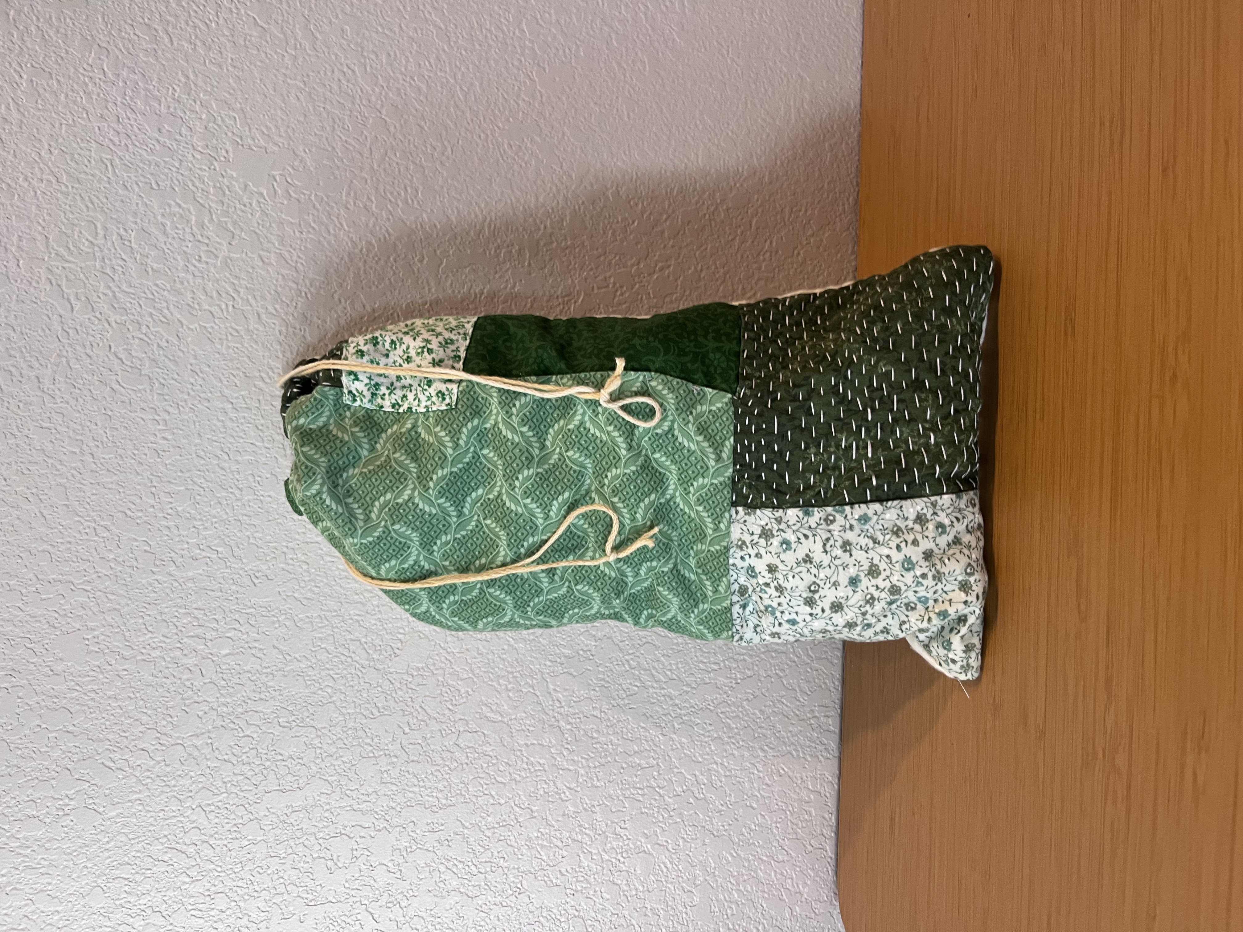 Photo of drawstring bag with green patchwork.