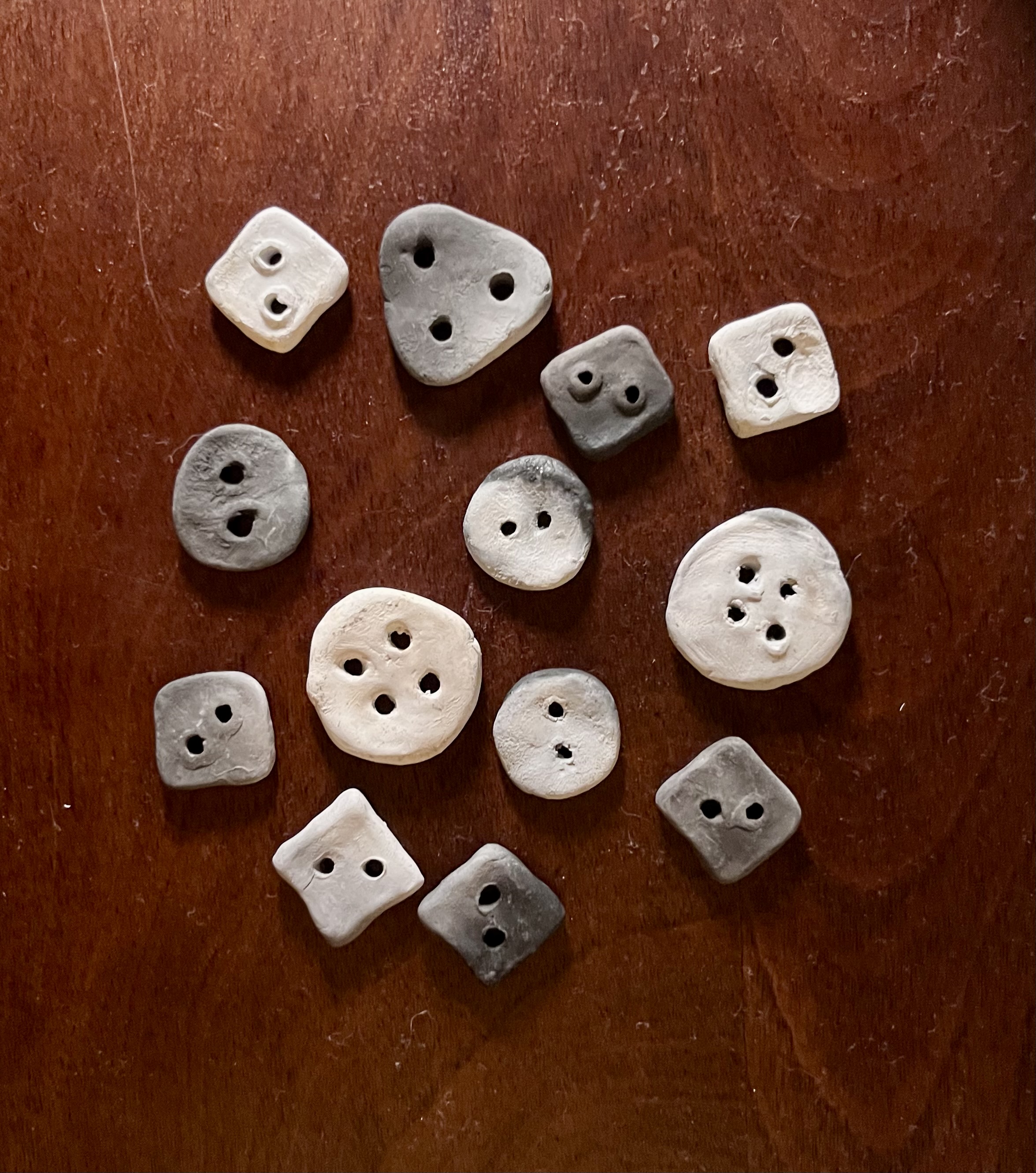 Clay buttons made with foraged clay and pit fired on the beach.